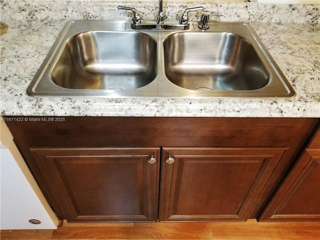 details with light wood-type flooring and sink