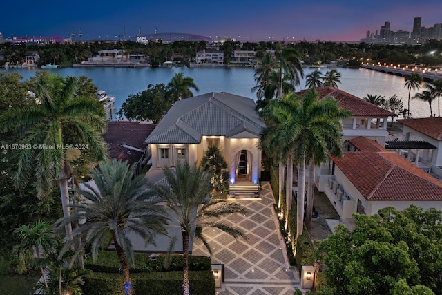 aerial view at dusk with a water view