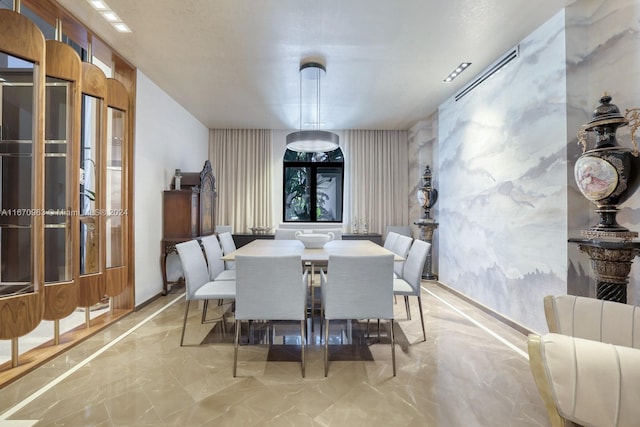 dining space with visible vents and marble finish floor
