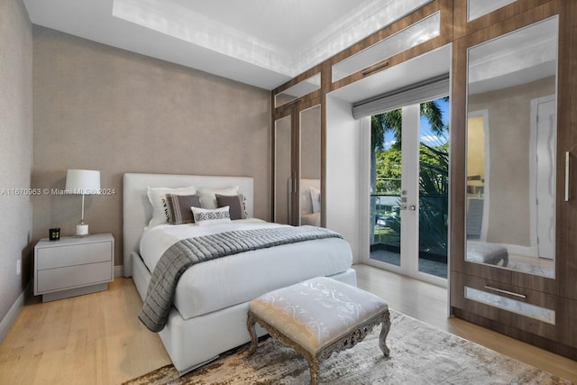 bedroom with light hardwood / wood-style flooring and access to exterior