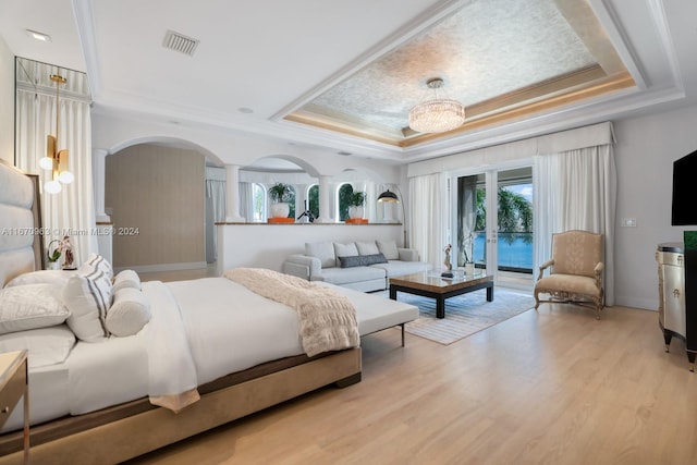 bedroom featuring ornate columns, access to outside, ornamental molding, visible vents, and a raised ceiling