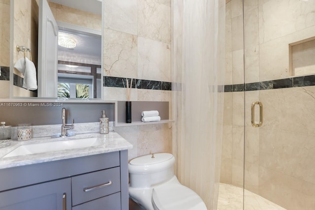 bathroom with toilet, a stall shower, tile walls, and vanity