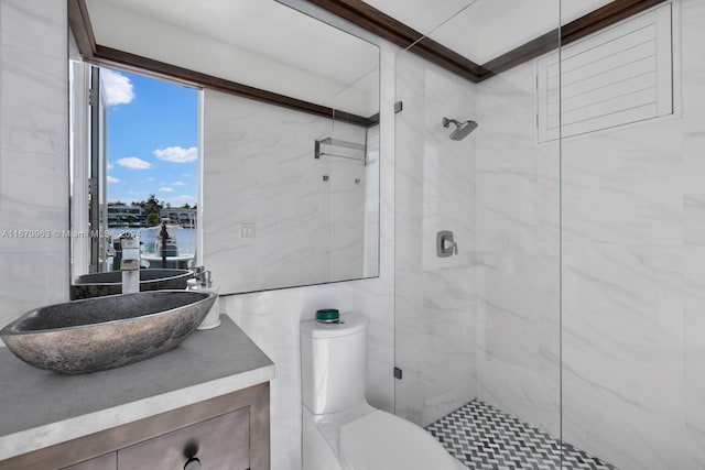 full bath with toilet, a marble finish shower, a water view, and vanity
