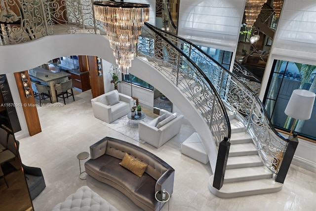 stairs with an inviting chandelier and a high ceiling