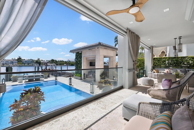 exterior space featuring an outdoor living space, a ceiling fan, and a water view