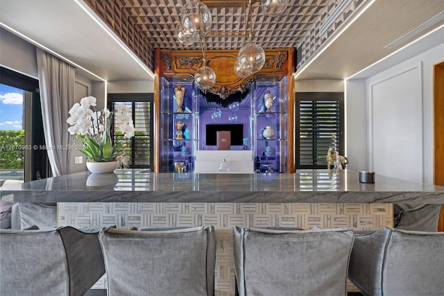 bar featuring a chandelier