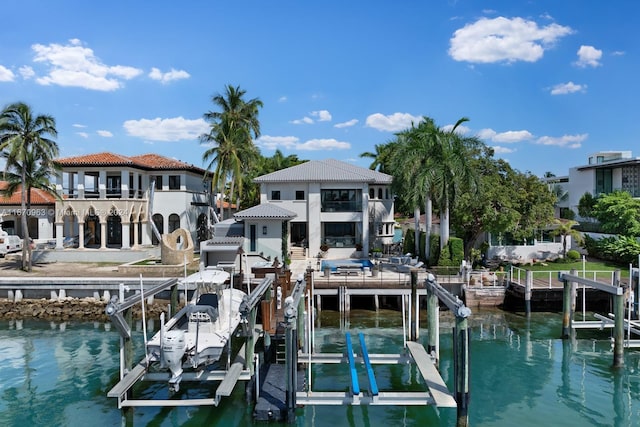 dock area with a water view and boat lift