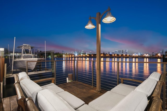 view of dock with an outdoor hangout area and a water view