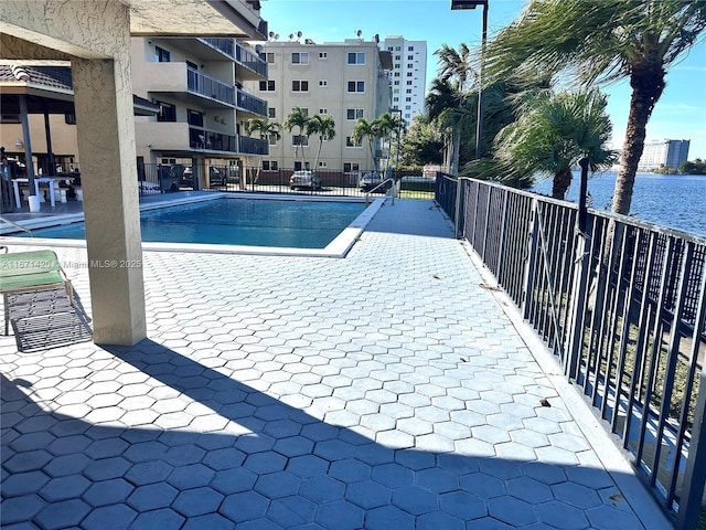 view of swimming pool with a water view