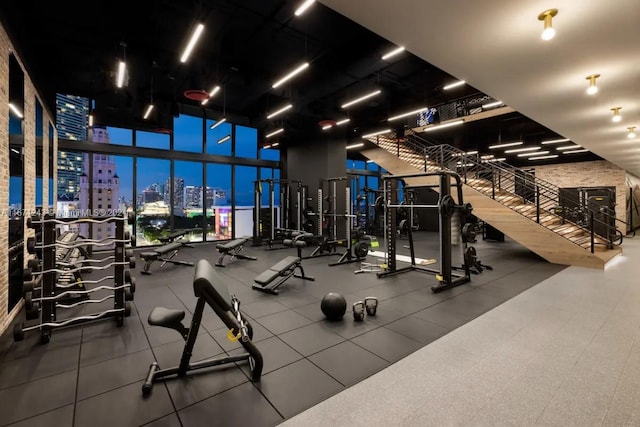 gym with a towering ceiling and expansive windows