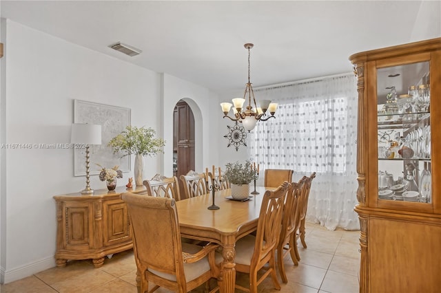 tiled dining space with a notable chandelier