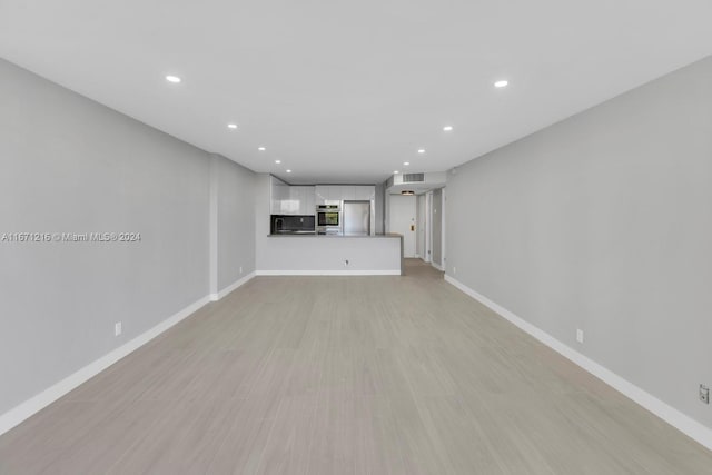 unfurnished living room featuring light wood-type flooring