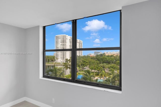 spare room with plenty of natural light and a water view