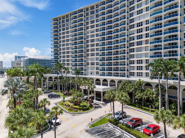 view of property with a view of city and uncovered parking