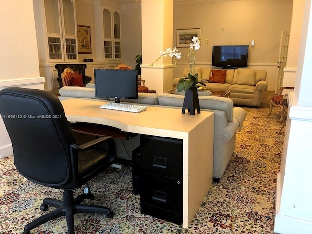 office area featuring built in desk and ornamental molding