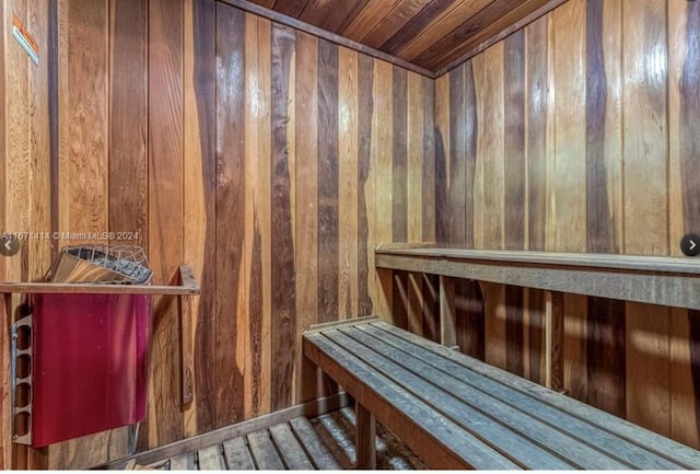 view of sauna / steam room featuring wooden walls and wooden ceiling