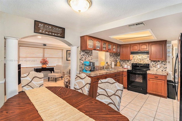 kitchen with ornate columns, black / electric stove, sink, tasteful backsplash, and light tile patterned floors