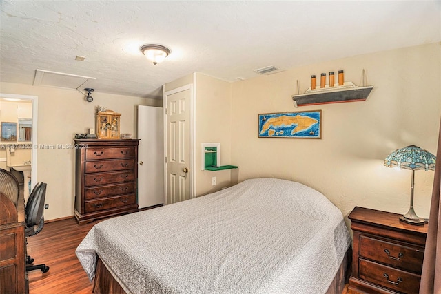 bedroom featuring dark hardwood / wood-style flooring