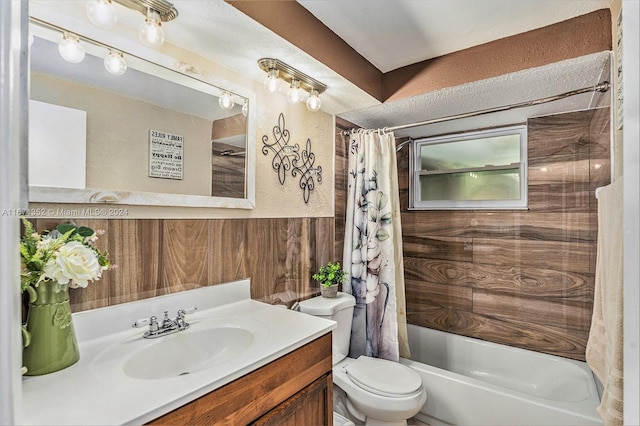 full bathroom with toilet, wood walls, vanity, and shower / bathtub combination with curtain