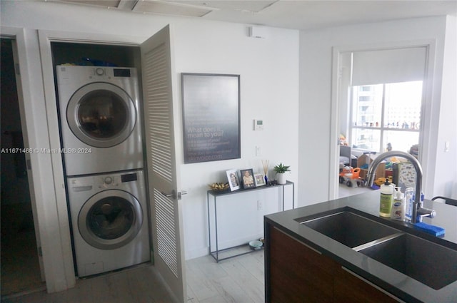 laundry room with sink and stacked washing maching and dryer