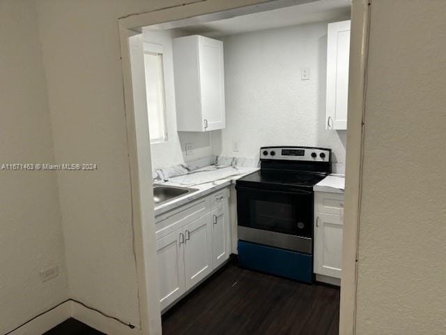 kitchen with electric stove, dark hardwood / wood-style floors, white cabinetry, and sink