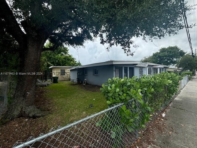 view of side of property with a yard