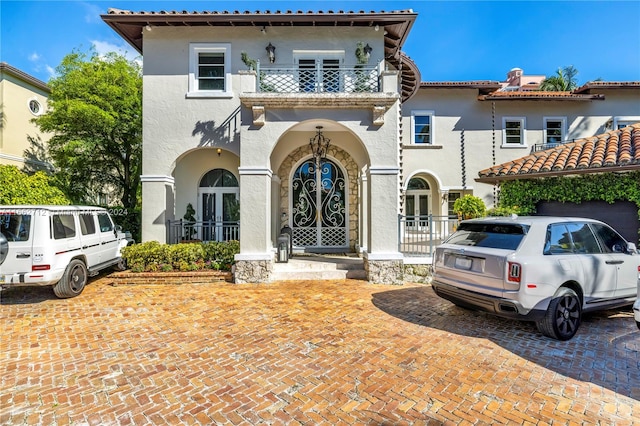 mediterranean / spanish home featuring a balcony