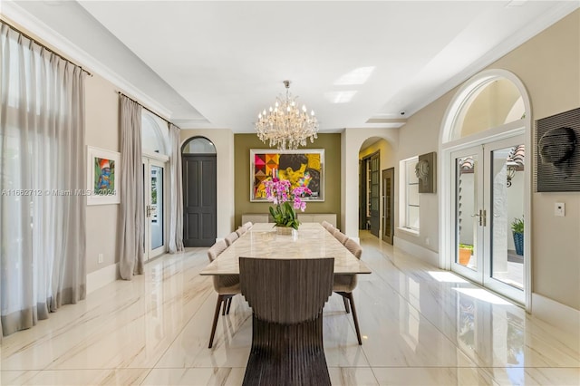 dining area with french doors and an inviting chandelier