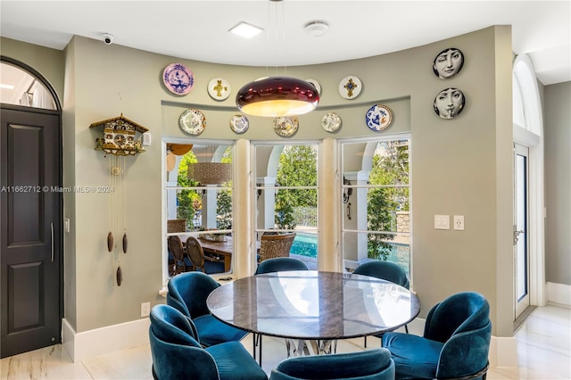 dining area with light tile patterned floors and a healthy amount of sunlight