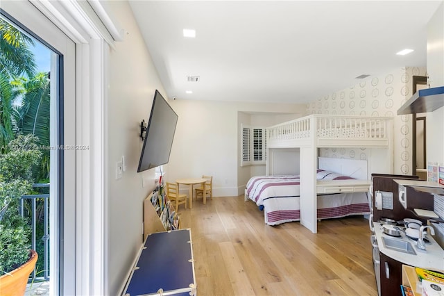 bedroom featuring access to outside and light hardwood / wood-style floors