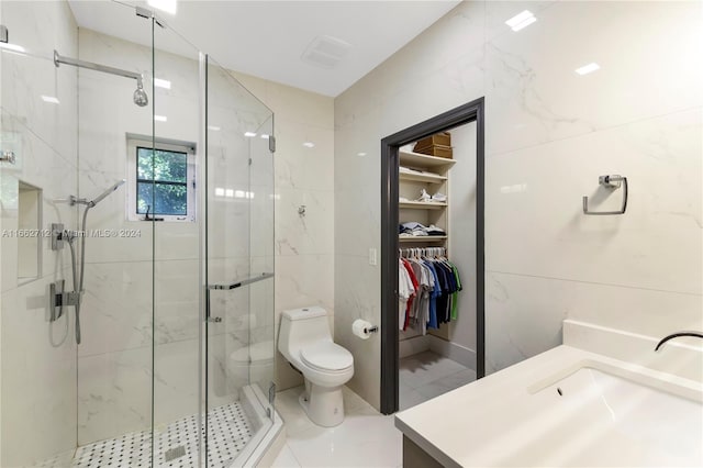 bathroom featuring vanity, toilet, and a shower with shower door