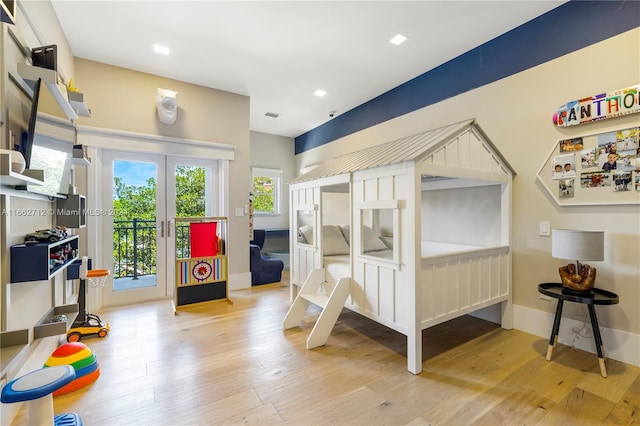 bedroom featuring light hardwood / wood-style floors and access to exterior