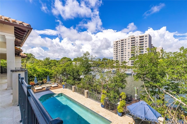 view of swimming pool with a water view