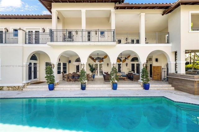 rear view of house featuring a patio area, french doors, and an outdoor hangout area