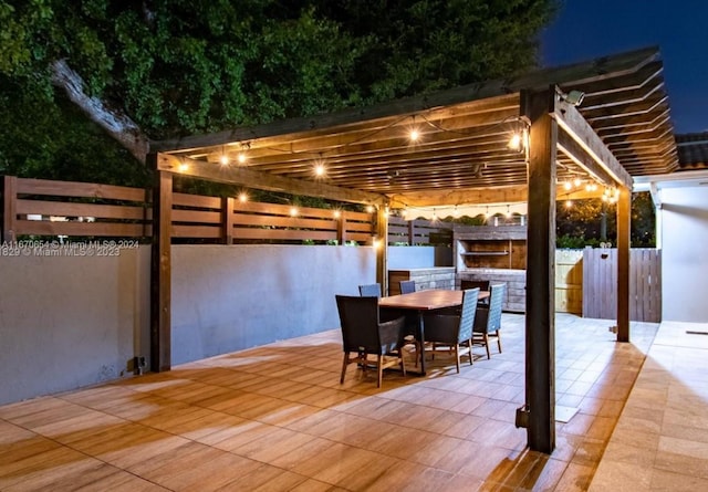 patio at twilight featuring a pergola