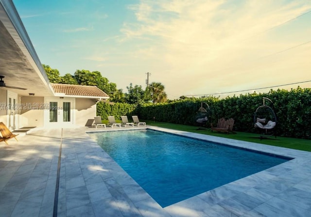 view of swimming pool with a patio area and french doors