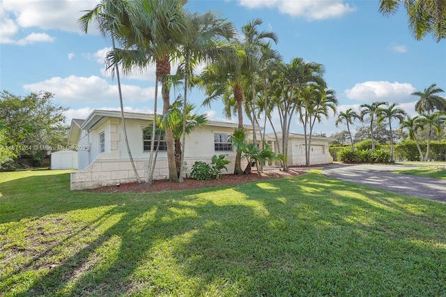 view of front of property with a garage and a front yard