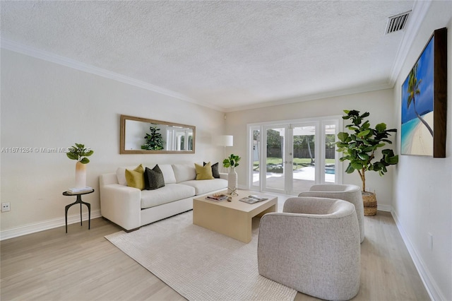 living area featuring a textured ceiling, light wood-style flooring, visible vents, french doors, and crown molding