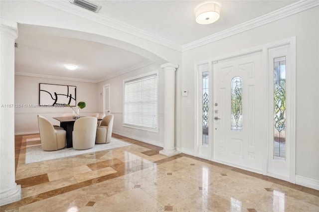 foyer with arched walkways, marble finish floor, decorative columns, visible vents, and baseboards