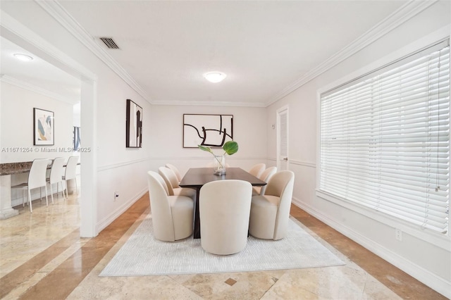 dining space with visible vents, crown molding, and baseboards