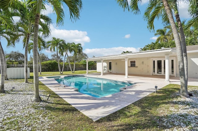 view of swimming pool featuring a patio area and french doors