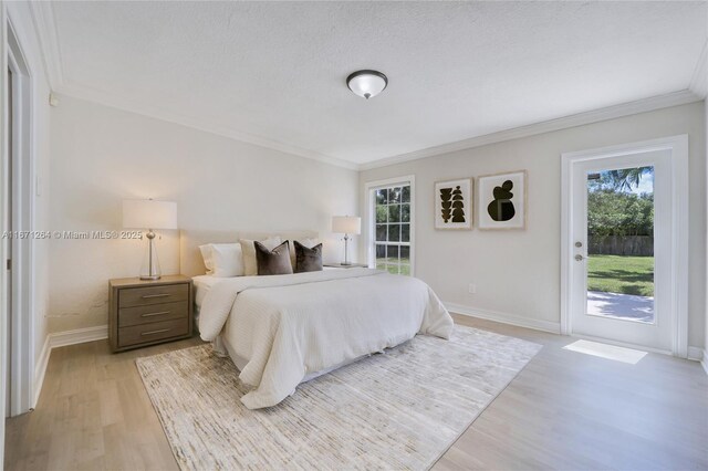 bedroom with light hardwood / wood-style floors, crown molding, access to outside, and a textured ceiling