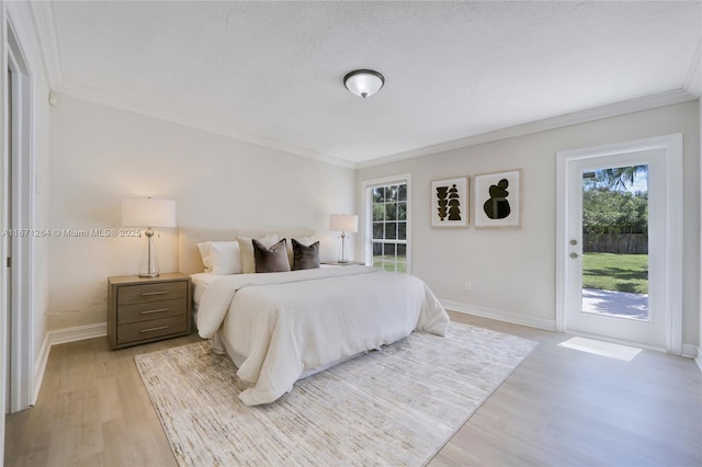 bedroom featuring a textured ceiling, baseboards, access to outside, ornamental molding, and light wood finished floors