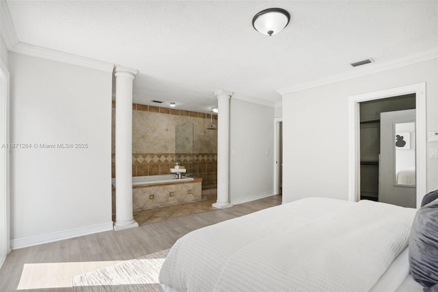 bedroom with baseboards, visible vents, ornamental molding, light wood-type flooring, and ornate columns