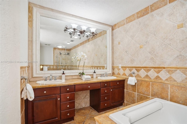 full bathroom featuring a stall shower, a sink, tile walls, and double vanity