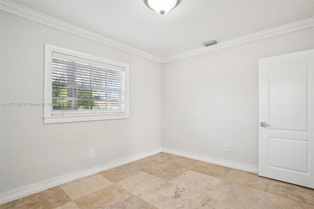 spare room with ornamental molding