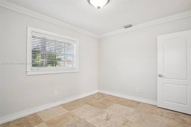 unfurnished room featuring crown molding, visible vents, and baseboards