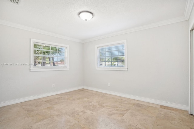 spare room with baseboards, ornamental molding, a textured ceiling, and a healthy amount of sunlight