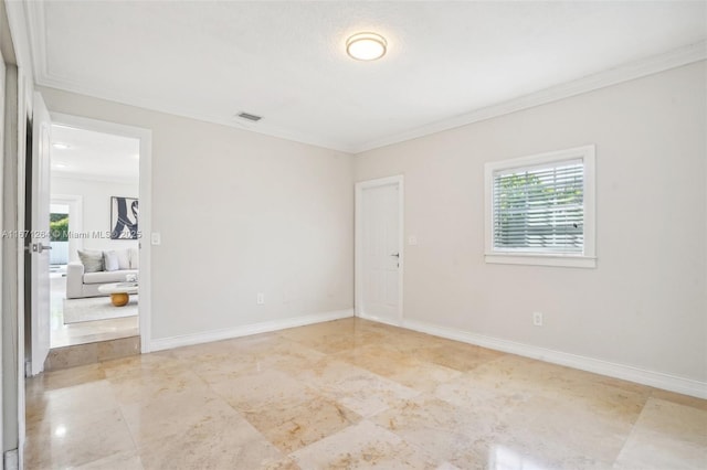 empty room with baseboards, visible vents, and ornamental molding