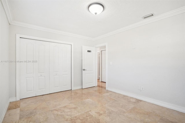 unfurnished bedroom with ornamental molding, a closet, visible vents, and baseboards